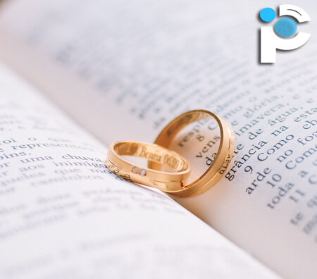 Gold engagement rings on a book