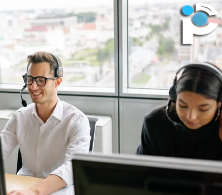 One man and one woman working in an office while wearing headsets