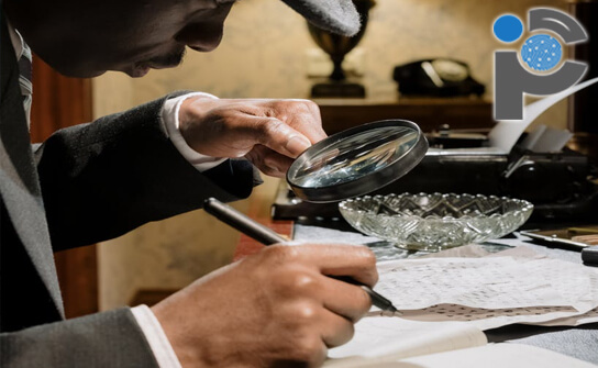 Private investigator looking at paperwork with a magnifying glass