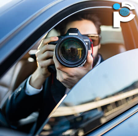 A private investigator taking photos