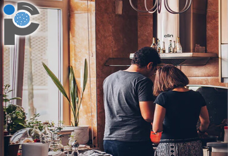 Couple cooking food inside a kitchen