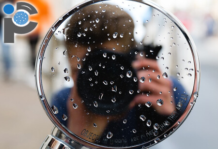 An agent pointing a DSLR camera at a mirror