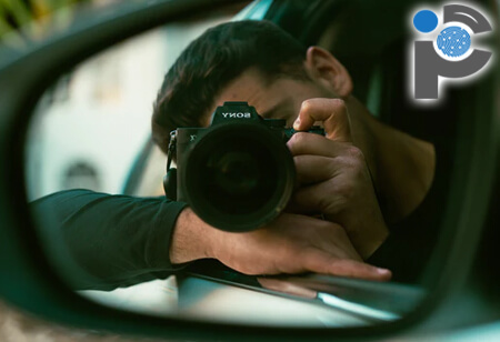 Investigator taking photos from a car